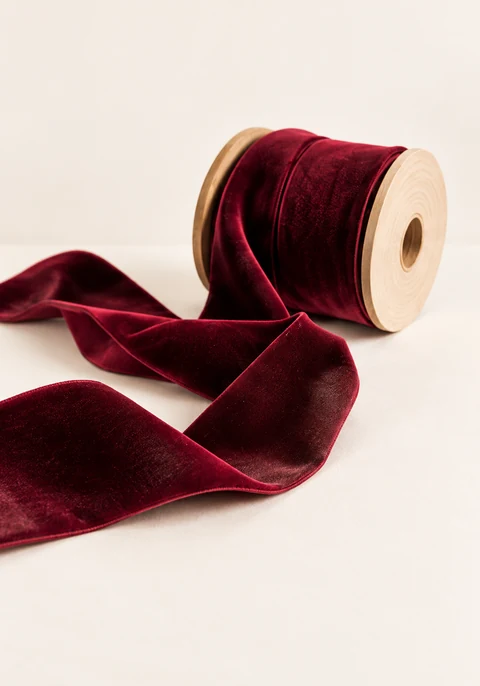 Category inspiration: Burgundy velvet ribbon on a wooden spool